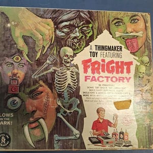 May include: A vintage Mattel Fright Factory Thingmaker toy box featuring horror-themed illustrations of a skeleton, faces, and hands. The box includes text such as A Thingmaker Toy Featuring Fright Factory, Glows in the Dark, and Be Frightful.