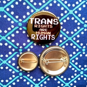 Trans Rights Are Human Rights pinback button. 1” or 1.5 inch hand-pressed Social Justice Protest and LGBTIA+ Queer pride pins or Mixed Batch