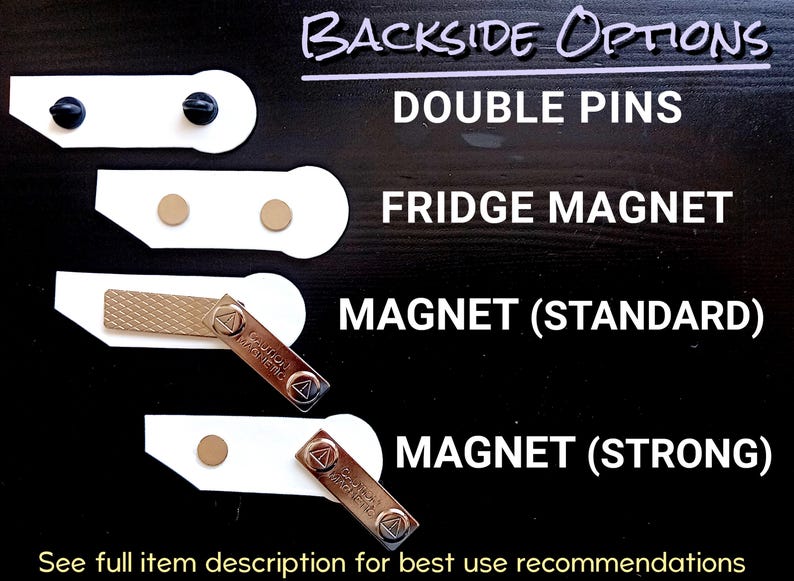 May include: A display showing four backside options for an item: double pins with black clutches, a fridge magnet with two circular magnets, a standard magnet bar with a metal plate, and a strong magnet bar with a single circular magnet.