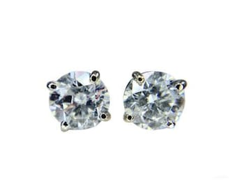 May include: A pair of silver stud earrings with clear round cubic zirconia stones.