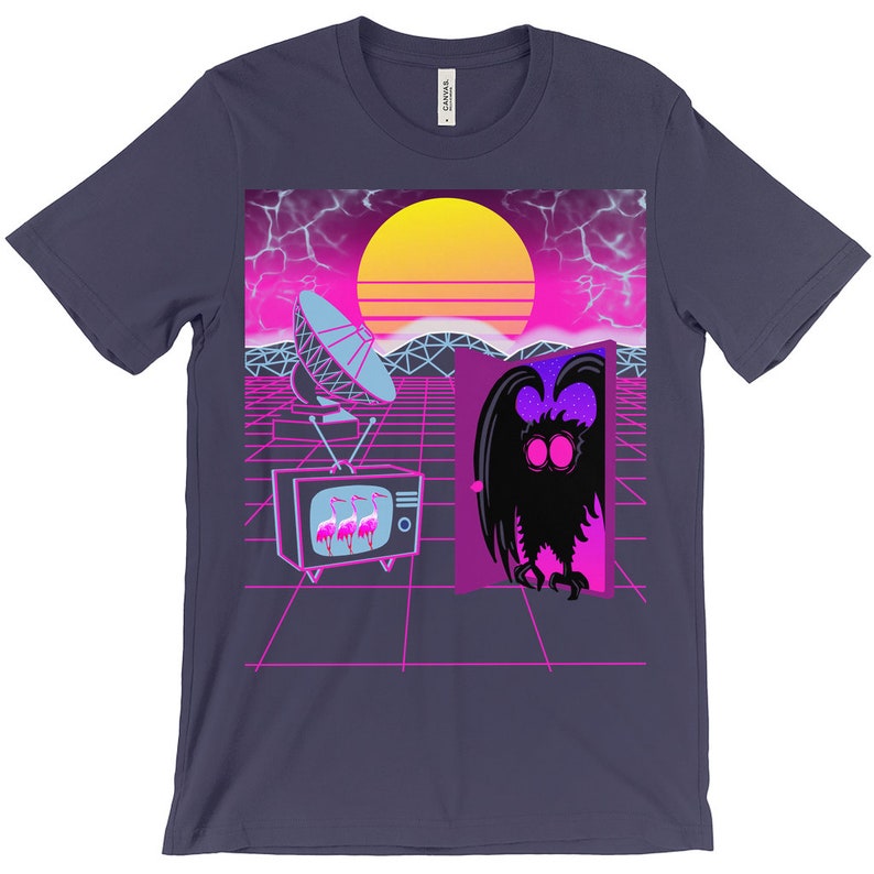 May include: A purple t-shirt with a retro 80s design featuring a satellite dish, a television with pink flamingos, a doorway with a purple and blue creature, and a sunset.