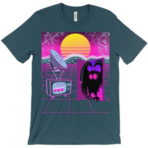 May include: A teal blue t-shirt with a retro 80s design featuring a pink and purple sunset, a satellite dish, a television with pink flamingos, and a creature with large eyes emerging from a door.