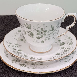 Queen Anne Bone China footed trio decorated with small pale green flowers.