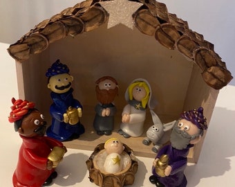 Unique and handmade nativity scene with wooden hut and fimo characters