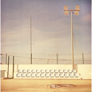 Empty sportsfield in Alentejo Portugal blue seats analogue photography medium format ready to print