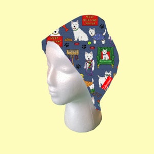 May include: A blue and white patterned surgical scrub hat with a repeating pattern of West Highland Terriers. The hat features a variety of poses of the dogs, including sitting, standing, and walking. The text "West Highland Terrier" is repeated throughout the pattern.