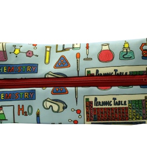 May include: A blue pencil case with a zipper closure. The case is decorated with a colorful pattern of chemistry-themed illustrations, including beakers, test tubes, molecules, and the periodic table. The text "CHEMISTRY" appears twice on the case.