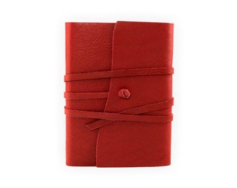 May include: A red leather journal with a wrap closure and a decorative button. The journal is made of a textured leather and has a rustic look.