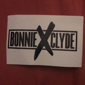 May include: Black and white sticker with the text "BONNIE X CLYDE" in a black rectangle.