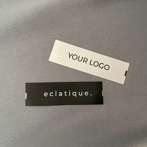 May include: Two rectangular labels, one white with black text "YOUR LOGO" and one black with white text "eclatique."