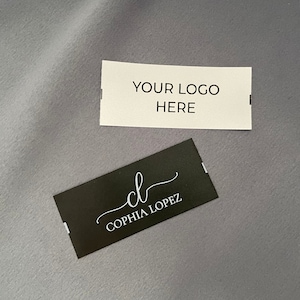 May include: Two white rectangular labels with black text. The top label says "YOUR LOGO HERE". The bottom label is black with white text and says "cl  COPHIA LOPEZ".