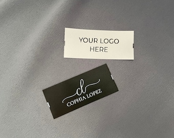 May include: Two white rectangular labels with black text. The top label says "YOUR LOGO HERE". The bottom label is black with white text and says "cl  COPHIA LOPEZ".