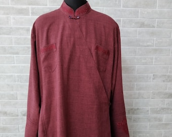May include: A long, burgundy robe with a mandarin collar and red embroidery. The robe has a long, flowing silhouette and is made of a soft, textured fabric.