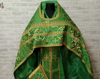 May include: A green and gold liturgical vestment set with a patterned design. The set includes a chasuble, stole, and a small pouch.