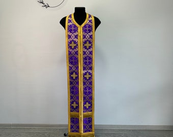 May include: Purple liturgical vestment with gold embroidery and trim. The vestment is displayed on a mannequin. The text "Ekklesia™ Church clothes" is visible in a circle above the mannequin.