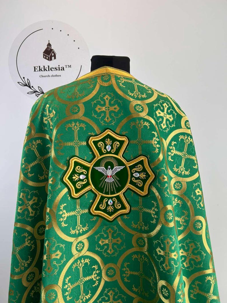 May include: Green liturgical vestment with a gold embroidered cross and a dove design. The vestment has a repeating pattern of crosses and circles.