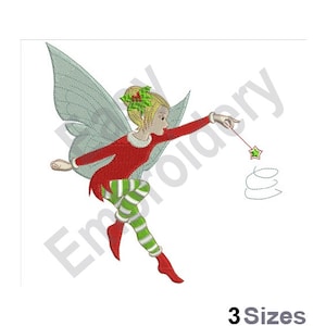 May include: A green and red Christmas fairy with wings, wearing a red dress and green and white striped tights, is flying and holding a wand with a star on the end.