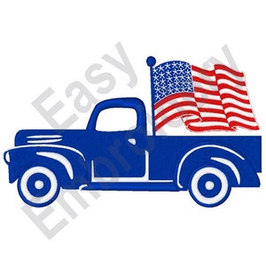 May include: A blue pickup truck with a waving American flag on the back. The truck has white wheels and a white stripe along the side.