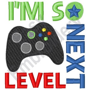 May include: Embroidered design featuring a black video game controller, green text that reads "I'M SO", a blue star, and blue text that says "NEXT LEVEL".
