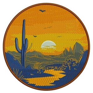 May include: Embroidered patch featuring a desert landscape with a large blue cactus, mountains, and a setting sun. The design includes a winding path and birds against an orange and yellow sky, all within a circular brown border.