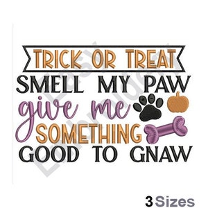 May include: Trick or treat, smell my paw, give me something good to gnaw. An embroidered design with a paw print, bone, and pumpkin.