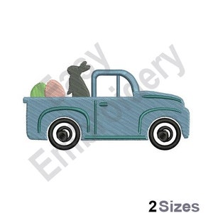 May include: A blue pickup truck with a bunny rabbit and two Easter eggs in the bed. The truck has black wheels and a white cab.