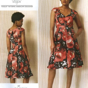 May include: A Vogue Patterns American Designer dress pattern by Tracy Reese. The dress features a V-neck, cap sleeves, and a knee-length skirt. The fabric has a floral print in red, black, and white. The pattern size is A5 (6-8-10-12-14).