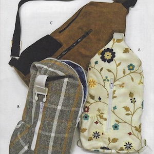 May include: Three different sling bags. One is brown suede with a black strap, one is a plaid fabric with a white strap, and one is white with a floral pattern and a white strap.