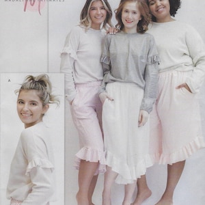 May include: Three women wearing long-sleeved shirts with ruffles on the sleeves and matching pants with ruffles at the bottom. The shirts are white, gray, and light pink. The pants are pink with white polka dots. The text "MADALYNNE INTIMATES" is visible at the top of the image.