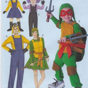 May include: A sewing pattern envelope titled COSTUMES featuring illustrations of five outfits: two yellow and blue minion-style costumes, one purple-haired character costume, and two green turtle-themed costumes with accessories like masks and toy weapons.