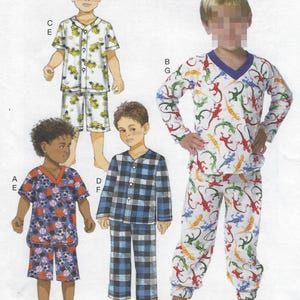 May include: A sewing pattern illustration featuring four pajama sets. One set has a white background with yellow construction vehicles, one has a blue and black plaid pattern, one has a dark blue sports ball print, and one has a white lizard print.