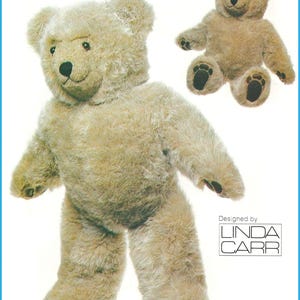 May include: A plush teddy bear with light brown fur, dark eyes, and a black nose. The bear is shown in two positions: standing and sitting. The paws feature dark brown pads. The text "Designed by LINDA CARR" is printed in the bottom right corner.