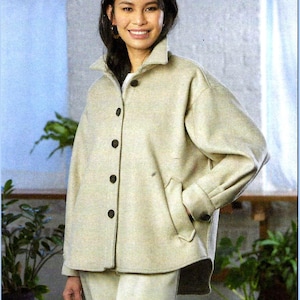 May include: A beige button-down jacket with a collar, long sleeves, and side pockets. The jacket features dark brown buttons down the front and on the cuffs. The text "MELISSA WATSON FOR PALMER/PLETSCH" is printed in white at the bottom right.