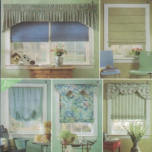 May include: A collection of window treatments including blue Roman shades with a floral valance, a solid olive green Roman shade, a sheer blue balloon shade, a floral Roman shade, and a green striped Roman shade with a floral scalloped valance.