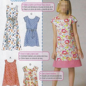 May include: A sewing pattern sheet featuring four dress designs for beginners. The dresses include a sleeveless peach dress, a blue polka dot dress with a belt, a floral print dress with a pink hem, and a long dress with a leaf pattern.