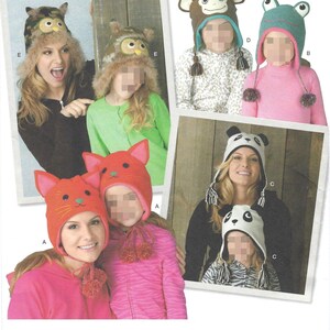 May include: A collection of animal-themed knit hats featuring various designs including an owl with camouflage patterns, a brown monkey, a green frog, a red cat with pointed ears, and a black and white panda. Each hat includes ear flaps and tassels.