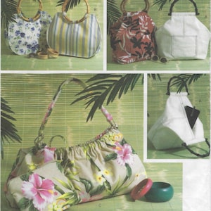 May include: A collection of fabric handbags featuring various designs including floral prints, striped patterns, and solid white with bamboo-style handles. The set includes a large gathered floral bag, a matching pouch, and several circular bangles.