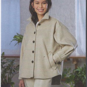May include: A beige button-up jacket with a collared neckline and two front pockets. The jacket is paired with matching beige pants. The image includes the text "MELISSA WATSON FOR PALMER/PLETSCH".
