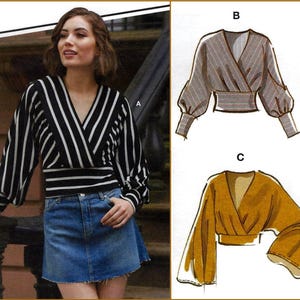 May include: A long-sleeve wrap top with a V-neckline and a wide waistband. The top features black and white vertical stripes, gathered sleeves with cuffs, and is shown alongside two technical sketches labeled B and C displaying variations.