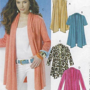 May include: A woman models a coral-colored cardigan with long sleeves, paired with white pants and a light blue belt. The image also shows four different cardigan designs: a sleeveless tan, a short-sleeved blue, a leopard print, and a pink cardigan. The text reads "HOUR CARDIGAN".