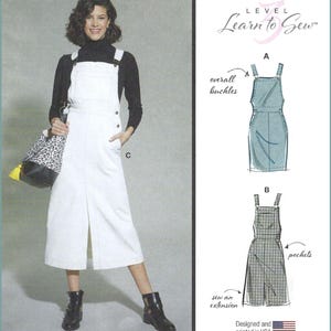 May include: A sewing pattern for a pinafore dress labeled Level 3 Learn to Sew. The image shows a white pinafore dress with a front slit, overall buckles, and pockets. Technical sketches illustrate variations A and B with details on buckles, pockets, and extensions. Designed and printed in USA.