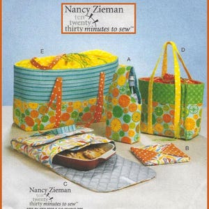 May include: A collection of fabric sewing projects by Nancy Zieman, including a large striped tote, a bottle carrier, a structured handbag, a casserole carrier with a quilted interior, and a small square pouch, all featuring citrus-themed prints.