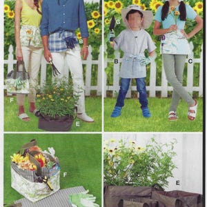 May include: A set of three gardening totes in brown fabric with handles. The totes are sitting on a green lawn with a green plant in the background. The totes are labeled with the letter "E".