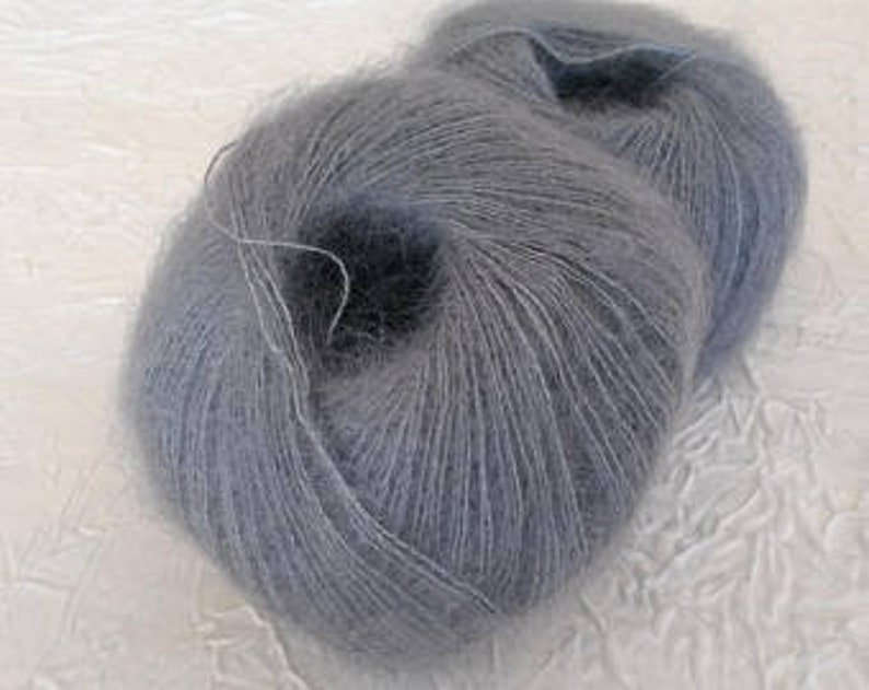 May include: Two skeins of light gray yarn, a soft and fuzzy mohair blend.