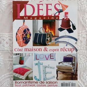 Peut inclure: Une couverture de magazine avec le titre "IDEES Magazine" avec un coussin en tissu à carreaux rouge et blanc, une pancarte en bois avec le mot "LOVE" et une pancarte en bois avec le mot "JE" en français. La couverture du magazine présente également le texte "Cote maison & esprit recup" et "Romantisme de saison Tricot, patchwork, couture, peinture..."