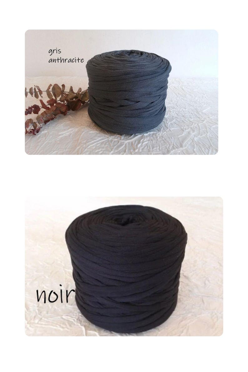 May include: Two spools of thick, dark gray and black fabric yarn. The top spool is labeled "gris anthracite" and the bottom spool is labeled "noir". The yarn is tightly wound, and the texture appears soft and pliable.