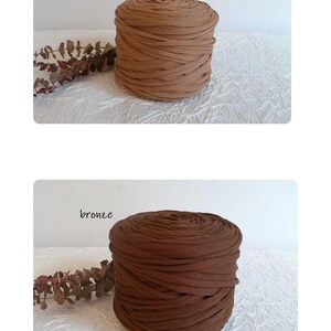 May include: Two spools of fabric yarn in shades of brown. The top spool is labeled "cannelle" and is a light brown color. The bottom spool is labeled "bronze" and is a darker brown color. Both spools are cylindrical.