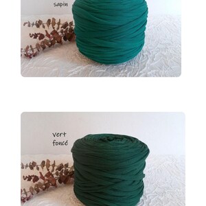 May include: Two spools of green fabric yarn. The top spool is a vibrant forest green, labeled "vert sapin." The bottom spool is a darker, deep green, labeled "vert fonc&eacute;." Both are on a white textured surface.