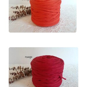 May include: Two spools of fabric yarn in the image. The top spool is orange, and the bottom spool is red. The text "rouge orang&eacute;" is above the orange spool, and the text "rouge" is above the red spool. The yarn is tightly wound.