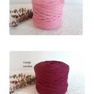 May include: Two spools of thick, knitted fabric in shades of pink and burgundy. The top spool is a light pink, labeled "rose", and the bottom spool is a deep burgundy, labeled "rouge carmin". Both are on a white textured surface.